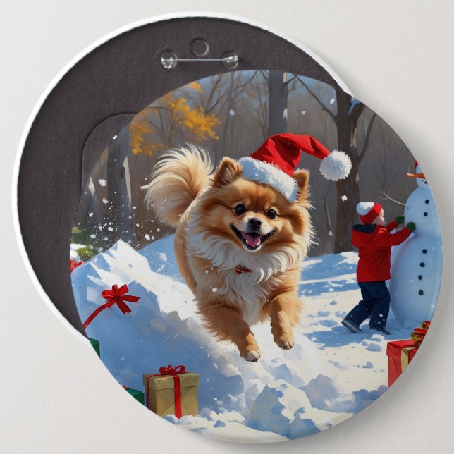 Pomeranian springer i snö med julhatt knapp (Framsida & baksida)