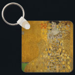 Porträtt i Adele Bloch-Bauer I av Gustav Klimt Nyckelring<br><div class="desc">Porträtt i Adele Bloch-Bauer I (1903-1907) av Gustav Klimt är en vintage av Viktorian Era Symbolism bra art porträtt. Porträtt i Adele Bloch-Bauer I kallas också Dam i Guld eller i Guld. I porträtt visas Adele Bloch-Bauer sitta på en guldstol framför en guldstjärnbakgrund. Hon bär en smyckad oker och en...</div>