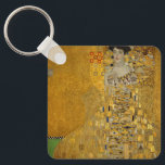 Porträtt i Adele Bloch-Bauer I av Gustav Klimt Nyckelring<br><div class="desc">Porträtt i Adele Bloch-Bauer I (1903-1907) av Gustav Klimt är en vintage av Viktorian Era Symbolism bra art porträtt. Porträtt i Adele Bloch-Bauer I kallas också Dam i Guld eller i Guld. I porträtt visas Adele Bloch-Bauer sitta på en guldstol framför en guldstjärnbakgrund. Hon bär en smyckad oker och en...</div>