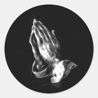 Praying händer runt klistermärke
