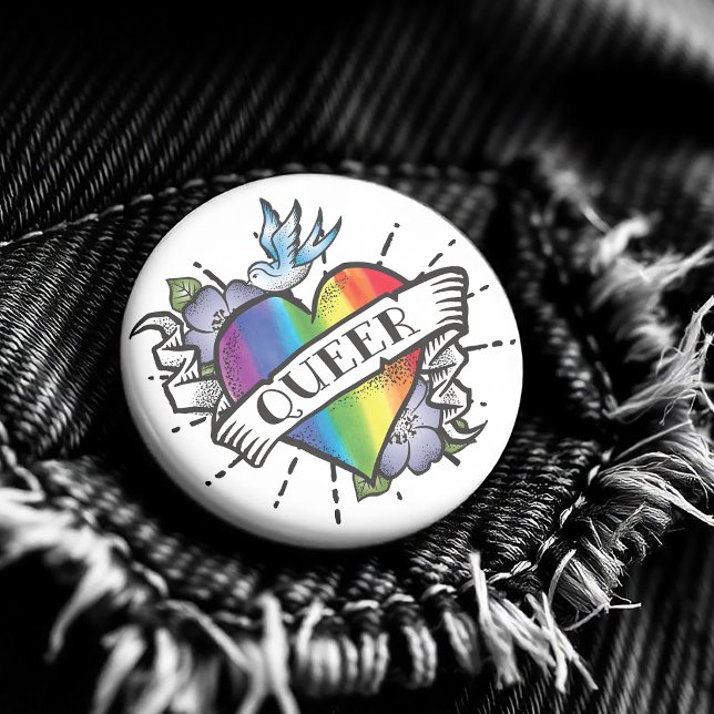 Queer Heart Tattoo Knapp ( Featuring a realistic image of a rainbow colored heart with Queer proudly written on the front. )