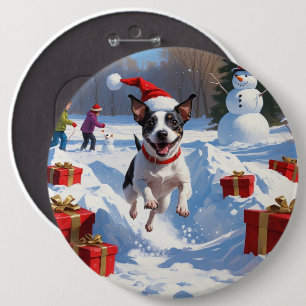 Råttterrier springer i snö med julhatt knapp