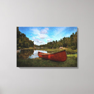 Red canoe på sjö-banken canvastryck