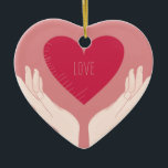 Red Heart kärlek romantic Valentine Day Julgransprydnad Keramik<br><div class="desc">romantisk design av ett starkt rosa hjärta med ord kärlek i mitten och två händer som håller upp hjärtat mot en  rosa. Den här vackra,  gigantiska snyggten är perfekt för valentindagen eller något annat romantiskt tillfälle.</div>