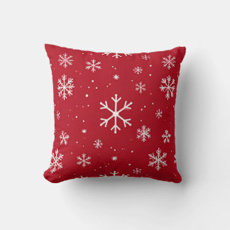 Red pillow with white snowflake pattern kudde