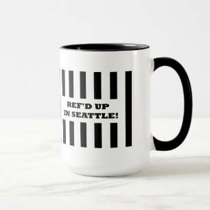 Ref reste i Seattle med ersättningsredit i Mugg