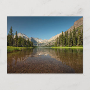 Reflektion av solnedgångsområde Glacier national Vykort