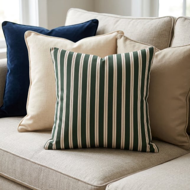 Retro ränder - Mörkgrön, Beige och Mörkröd Kudde (A pillow with a retro inspired stripe pattern sits on a couch in front of several other pillows.)