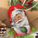 Retro Winking Jultomten jul Presentetikett<br><div class="desc">Juletiketterna har ett leende Jultomten,  som vinkar medan han kontrollerar sin stygga eller trevliga lista. Märkrns baksida kan anpassas med verktyg som designredigering.</div>