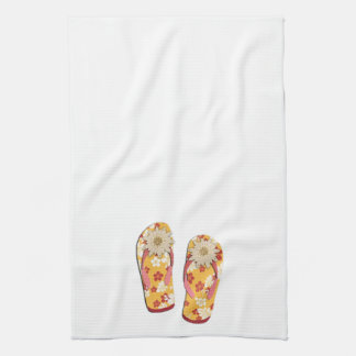Röd & guld- hibiskusblommaflinflip flops på vit kökshandduk