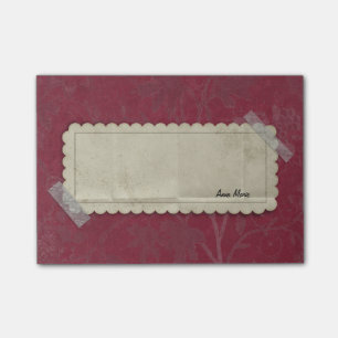Röda Burgundy blommar med den tejpade etiketten Post-it Block
