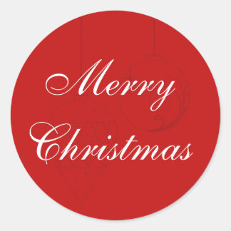 Röda julomslag med prydnadsföremål runt klistermärke