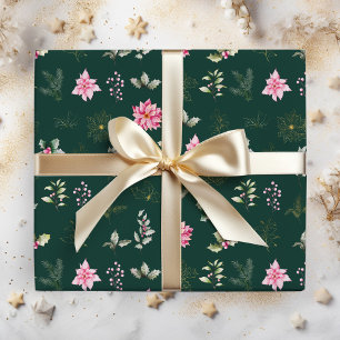 Röda julstjärnor blommor och löv på mörkgrön presentpapper