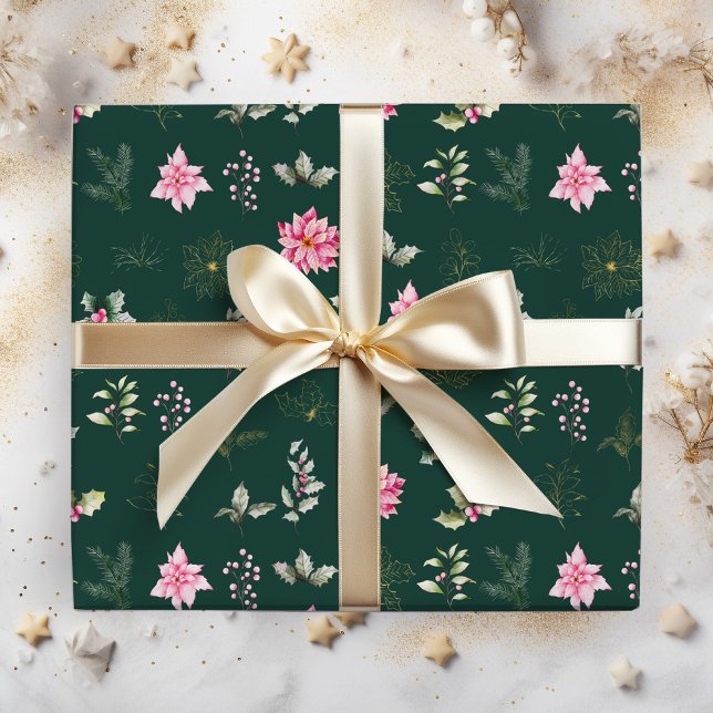 Röda julstjärnor blommor och löv på mörkgrön presentpapper (Skapare uppladdad)