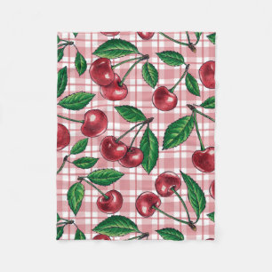 Röda körsbär på rosa gingham fleecefilt