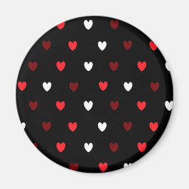 Röda och vita hjärtan på svart magnet