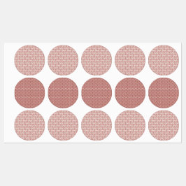 Röda textilier och rosa som lagts över ett skyddat klistermärke