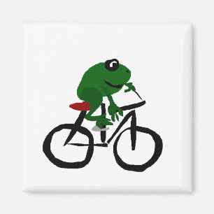 Rolig grön groda som rider en cykel magnet