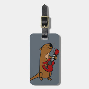 Rolig havsutter som leker gitarren bagagebricka
