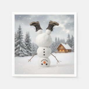 Rolig snöman som gör en huvudstående pappersservett