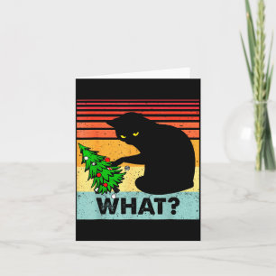 Rolig svart katt present som knuffar omkull julgra kort