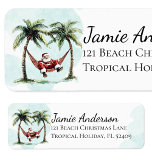 Roligt Beach Santa Tropical Returadress Returadress Etikett<br><div class="desc">Sprid ut dina kustmeddelanden med den här vismliga vattenfärgsstranden juldesign! Jultomten sparkar tillbaka i sitt röda kostym på en hammock mellan två handflatan träd. Det är perfektens sätt att få med lite tropisk glädje till din säsongshälsning.</div>
