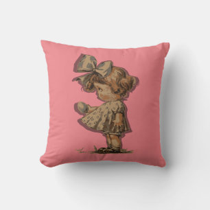 Rosa Dekorativ kudde med liten flicka och båge.