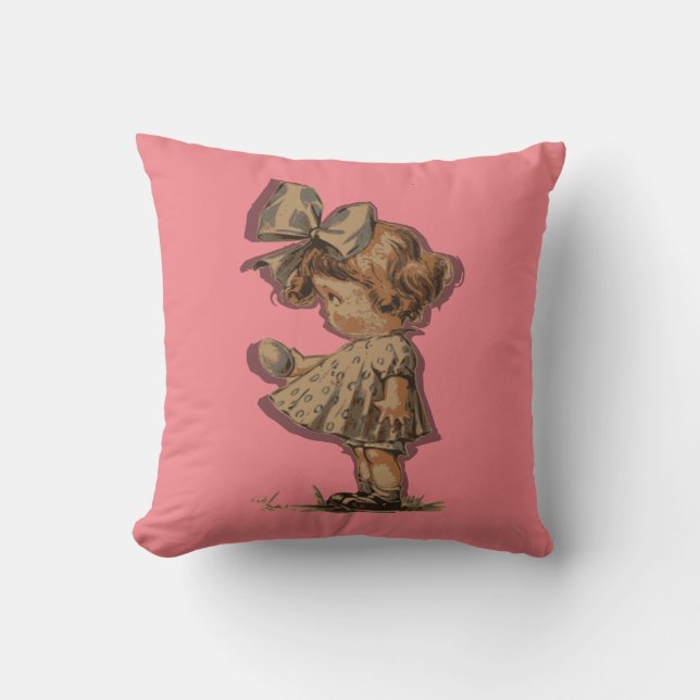 Rosa Dekorativ kudde med liten flicka och båge. (Framsida)