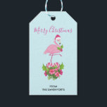 Rosa Flamingo i Santa Hat Whimsical jul Presentetikett<br><div class="desc">Ge märkre med ett tropiskt tema julflamingo med en rosa julhatt. Under fötterna är en candy cane bouquet med tropiska blommor och rosa söt. En myrsprit på bröstet.</div>