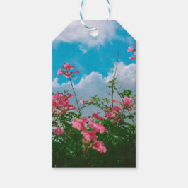 Rosa Flowers under Blå himmel med moln - natur Presentetikett