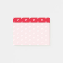 Rosa hjärtan på rött med bleknat skrivområde post-it block
