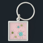 Rosa Iconic Atomic Starbursts Keychain Fyrkantig Silverfärgad Nyckelring<br><div class="desc">Den här Rosa Iconic Atomic Starbursts Keychain mönster har ikoniska atomstjärnor. Det är höger! Bakgrunden till färgaden old school, första Dam Rosa med guld-spektrum är perfektens bakgrund för färgaden av pulserande turkos, soothing celery och kitschy pear grönt circles. Sportarna i färg placeras sporadiskt i olika storlekar med överliggande V-formad linjer...</div>