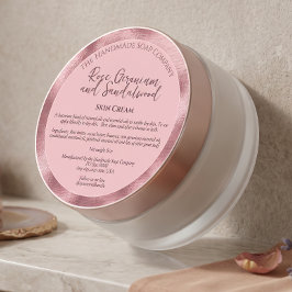 Rosa kosmetikburksetikett med ingredienser runt klistermärke