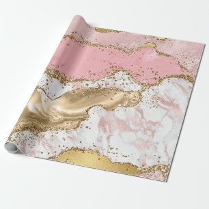 Rosa och vit sten med guldglitteragat presentpapper