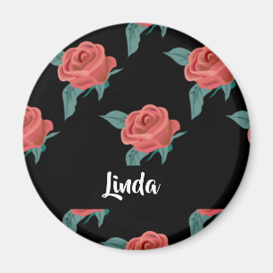 Rosa ros på svart magnet