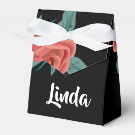 Rosa ros på svart presentaskar