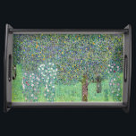 Rosbuskar under Träd, Gustav Klimt Frukostbricka<br><div class="desc">Gustav Klimt (14 juli, 1862 - 6 februari 1918) var en österrikisk symbolmålare och en av de mest framstående medlemmarna i Wien Secession-rörelsen. Klimt noteras för målningar, murar, skisser och andra föremål d'art. Förutom hans verk, som innefattar anklagelser och porträtt, målade han upp landskap. Klimt var bland konstnärer från Wienutträdet...</div>