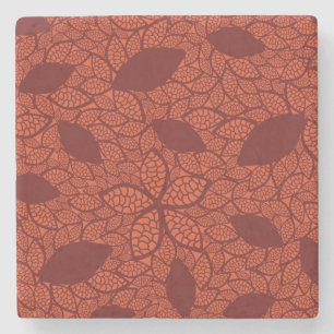 Rött lövmönster på orangen underlägg sten