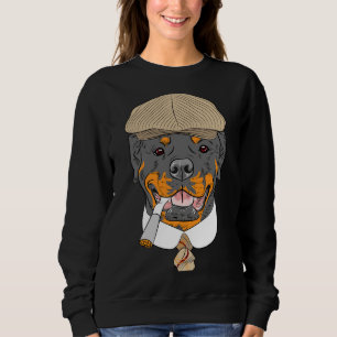 Rottweiler av Hund i en brun kapsyl med en T Shirt