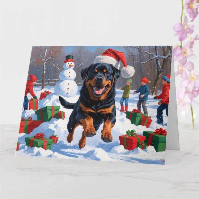 Rottweiler springer i snö med julhatt kort (Orkide)