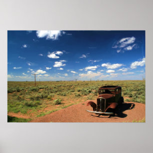 Rusted Car in Desert Paeing Poster