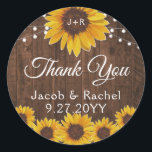 Rustic Solblommor String Ljus Wood Bröllop Runt Klistermärke<br><div class="desc">Den här bröllop-utformningen har söt målad, vattenfärgad solrosor på en rustik träbakgrund accentuerad med ljus. Klicka på anpassningsknappen om du vill ha mer flexibilitet när du ändrar texten eller flyttor grafiken! Det finns både variationer i denna design och samordnade produkter i vår butik, zazzle.com/store/doodlelulu. Kontakta oss om du behöver den...</div>