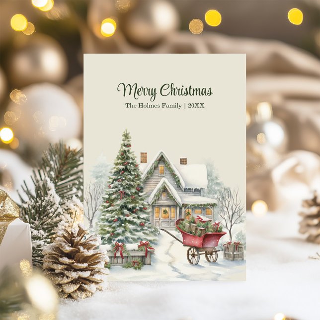 Rustik julstuga med Träd och röd vagn Julkort (Rustic Christmas Cottage with Tree and Red Wagon Holiday Card on a table with Christmas decor)