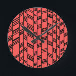 Salmon Art Deco Linjer Rund Klocka<br><div class="desc">Den här klockan har en konsdeco-design av svart lodrät linjer med svart diagonalt linjer som förbinder dem på en fält lax.</div>