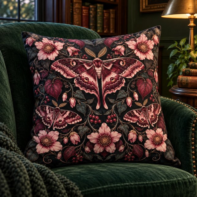 Sammetsmottsträdgård Tränings kudde (Styled preview of the 16 x 16 inch cotton throw pillow with matching printed artwork on both sides. The moth and floral details are flat printed artwork. Decorative furniture and accessories are not included.)