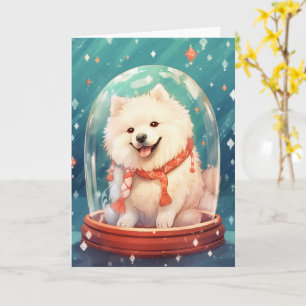 Samojed i en julsnöglob med starka ljus kort