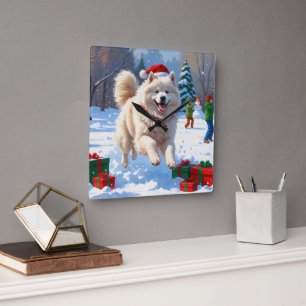 Samojed springar i snö med julhatt fyrkantig klocka
