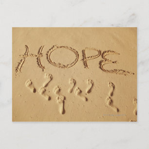 Sand skriver "Hope" på stranden med Vykort