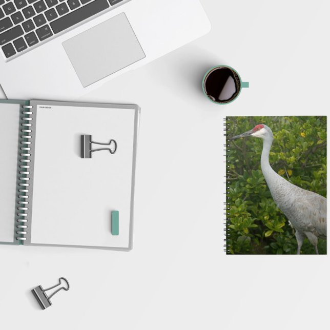 Sandhill Crane Bird Grönt Lövs Photo Anteckningsbok (A notebook featuring a photo of a sandhill crane in front of green leaves.)
