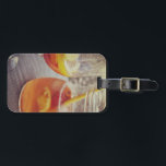 Sangria and Sunshine Bagagebricka<br><div class="desc">This image shows a refreshing glass and pitcher of citrus sangria, perfect for a warm day. The fresh slices of lemon and orange add bright colour and hint of natural sweetness. One glass sits ready to enjoy while sangria is being poured from a small glass pitcher beside it, perfect for...</div>